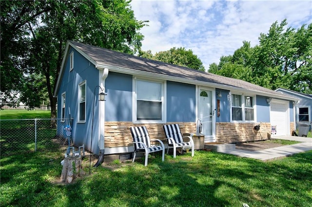 3136 S 8th St, Kansas City, KS 66103 - view of front of home with stone siding, a garage, and stucco siding