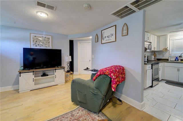 3136 S 8th St, Kansas City, KS 66103 - living area with baseboards and a textured ceiling