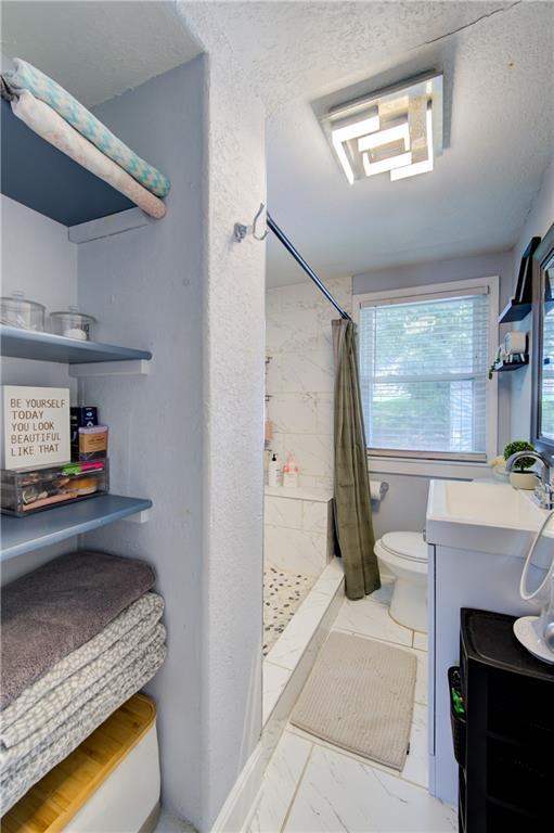 3136 S 8th St, Kansas City, KS 66103 - full bath featuring marble finish floors, a shower stall, and vanity