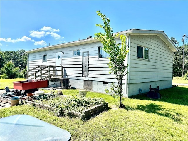 14444 E Quail Rd, Nevada, MO 64772 - view of home's exterior with a lawn and crawl space