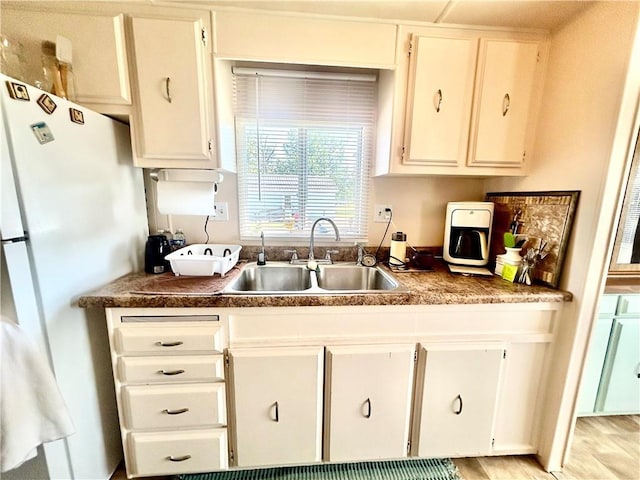 14444 E Quail Rd, Nevada, MO 64772 - kitchen with freestanding refrigerator and white cabinets