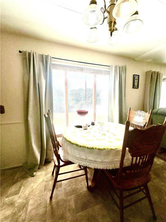 14444 E Quail Rd, Nevada, MO 64772 - dining space with a chandelier and plenty of natural light