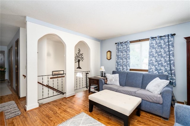 303 W S St, Spring Hill, KS 66083 - living area featuring light wood-style flooring and arched walkways