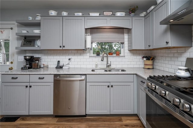 303 W S St, Spring Hill, KS 66083 - kitchen with appliances with stainless steel finishes, range hood, backsplash, and light stone counters