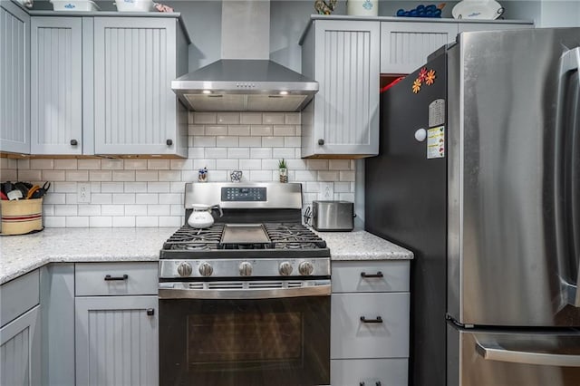 303 W S St, Spring Hill, KS 66083 - kitchen featuring stainless steel appliances, wall chimney exhaust hood, decorative backsplash, and light stone countertops
