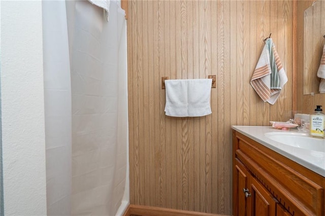303 W S St, Spring Hill, KS 66083 - bathroom with a tile shower, vanity, and wood walls