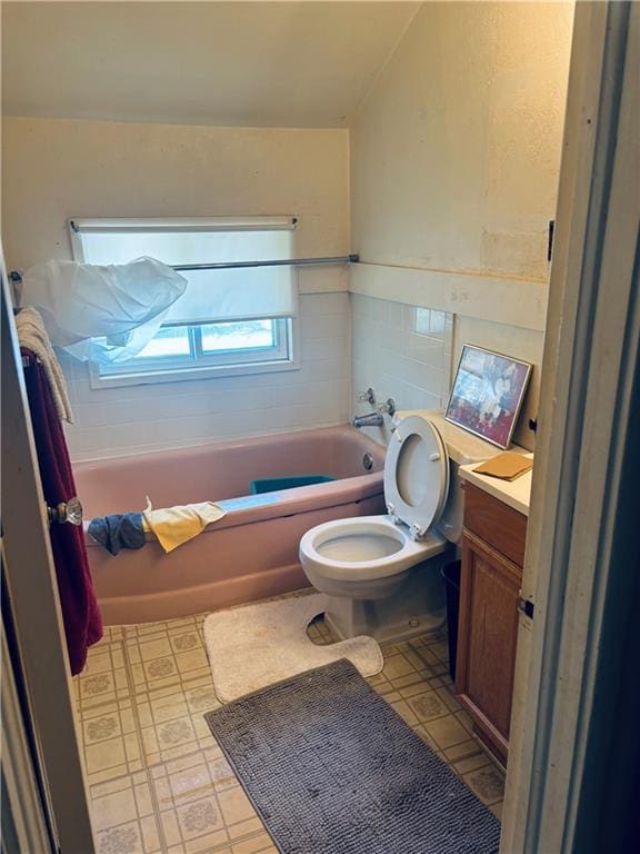 2506 S 48th Ter, Kansas City, KS 66106 - full bath featuring a bathtub, vanity, and tile walls