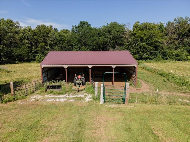 29309 E State Route B, Archie, MO 64725 - view of front of property with an outbuilding, a metal roof, and a forest view