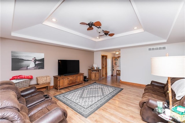 29309 E State Route B, Archie, MO 64725 - living room with a tray ceiling, light wood-type flooring, a ceiling fan, and recessed lighting