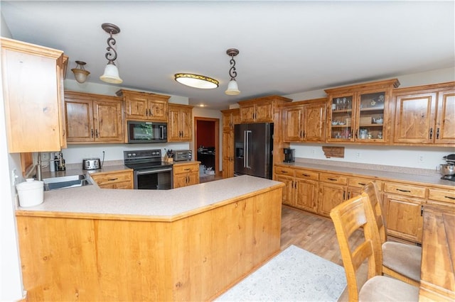 29309 E State Route B, Archie, MO 64725 - kitchen with black appliances, light countertops, glass insert cabinets, and decorative light fixtures