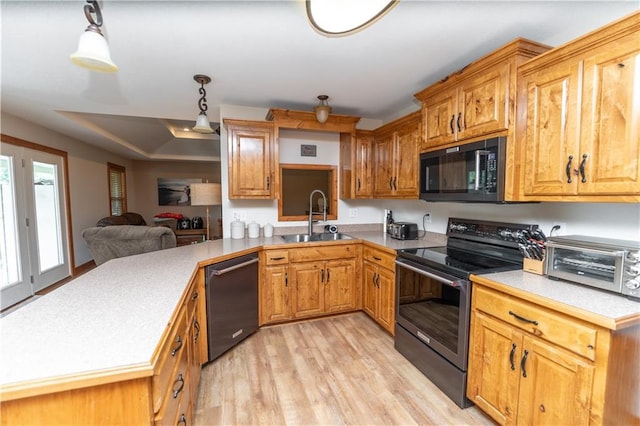 29309 E State Route B, Archie, MO 64725 - kitchen with black appliances, light countertops, light wood-type flooring, and decorative light fixtures