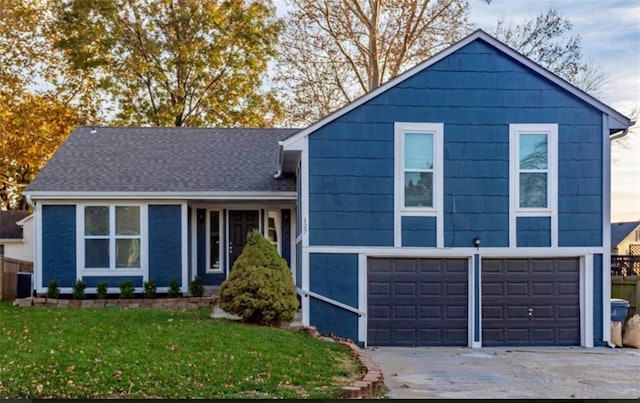 127 E Nelson Cir, Olathe, KS 66061 - view of front of house with an attached garage, driveway, and a front lawn