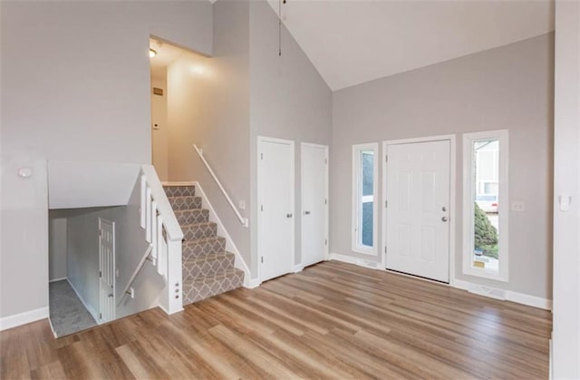127 E Nelson Cir, Olathe, KS 66061 - entrance foyer with high vaulted ceiling and light wood-type flooring
