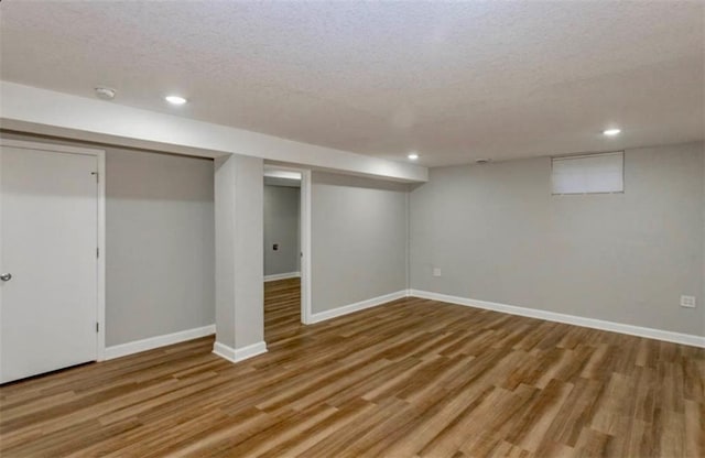 127 E Nelson Cir, Olathe, KS 66061 - finished below grade area featuring a textured ceiling, wood finished floors, and recessed lighting