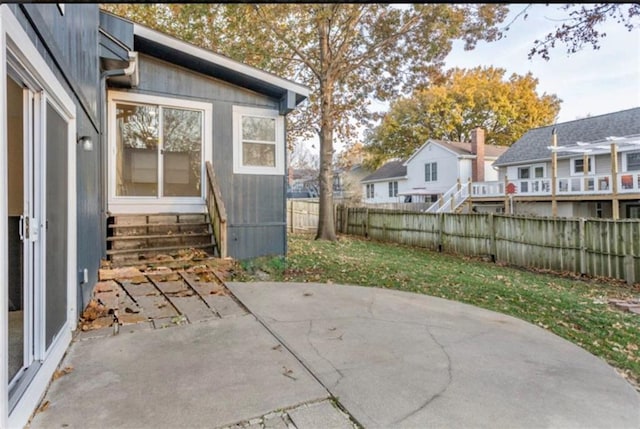 127 E Nelson Cir, Olathe, KS 66061 - fenced backyard with a patio area, entry steps, and a residential view