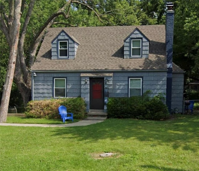 10216 W 60th Ter, Shawnee, KS 66203 - cape cod home featuring a chimney, a front yard, and a shingled roof