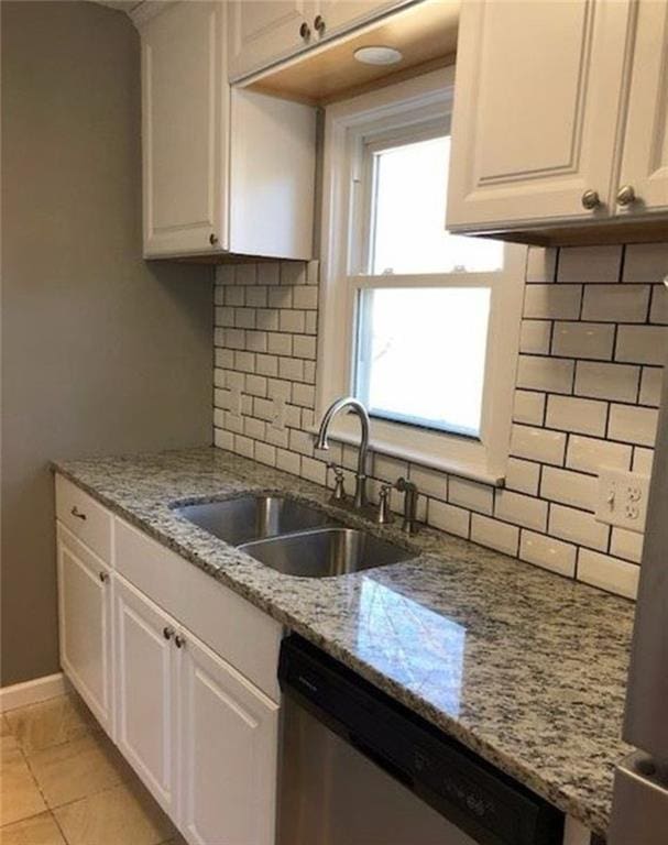 10216 W 60th Ter, Shawnee, KS 66203 - kitchen featuring stainless steel dishwasher, white cabinetry, tasteful backsplash, and light stone counters