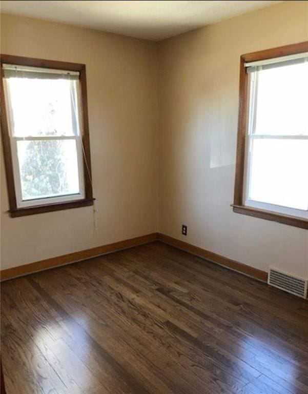 10216 W 60th Ter, Shawnee, KS 66203 - unfurnished room with dark wood finished floors and plenty of natural light