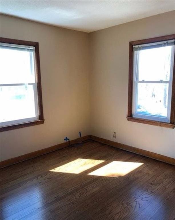 10216 W 60th Ter, Shawnee, KS 66203 - spare room with wood finished floors and plenty of natural light