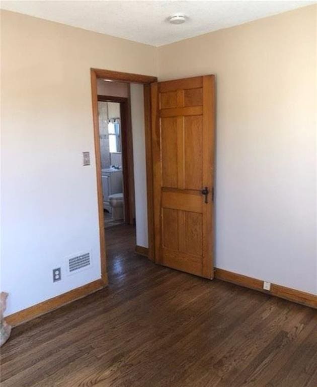 10216 W 60th Ter, Shawnee, KS 66203 - unfurnished room featuring dark wood finished floors and a smoke detector