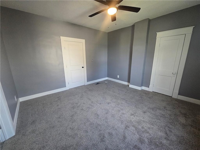 2113 Jefferson St, Lexington, MO 64067 - unfurnished bedroom featuring dark carpet and ceiling fan