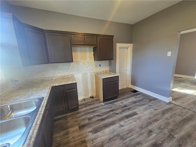 2113 Jefferson St, Lexington, MO 64067 - kitchen with dark wood-type flooring, decorative backsplash, and dark brown cabinets