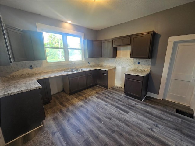 2113 Jefferson St, Lexington, MO 64067 - kitchen featuring tasteful backsplash, dark wood finished floors, dark brown cabinets, and light countertops