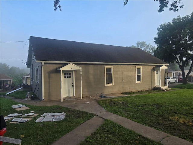 2113 Jefferson St, Lexington, MO 64067 - back of property with concrete block siding, a lawn, and roof with shingles
