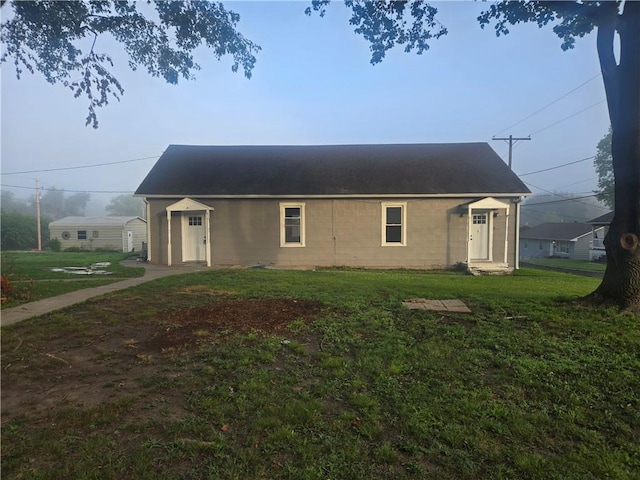 2113 Jefferson St, Lexington, MO 64067 - view of home's exterior featuring a lawn and concrete block siding