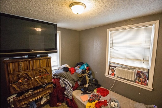 5521-3 Wabash Ave, Kansas City, MO 64130 - bedroom featuring a textured ceiling, multiple windows, and cooling unit