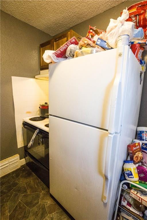 5521-3 Wabash Ave, Kansas City, MO 64130 - kitchen with freestanding refrigerator, electric range, range hood, and a textured ceiling