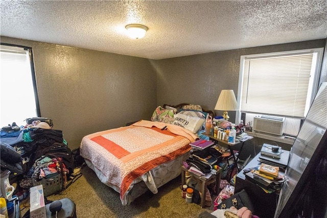 5521-3 Wabash Ave, Kansas City, MO 64130 - carpeted bedroom featuring a textured wall, cooling unit, a textured ceiling, and multiple windows