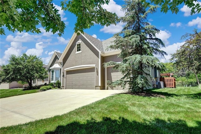 14780 S Glen Eyrie St, Olathe, KS 66061 - view of front of home with driveway, stucco siding, and a front lawn