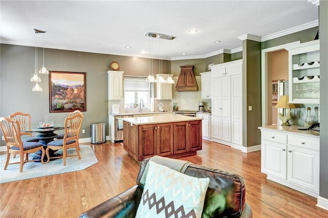 14780 S Glen Eyrie St, Olathe, KS 66061 - kitchen with light countertops, light wood-style floors, dishwasher, a center island, and white cabinetry