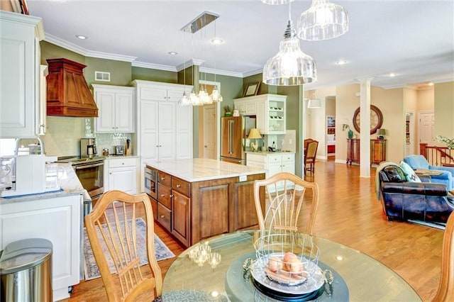 14780 S Glen Eyrie St, Olathe, KS 66061 - kitchen featuring appliances with stainless steel finishes, light wood-style flooring, tasteful backsplash, custom range hood, and crown molding