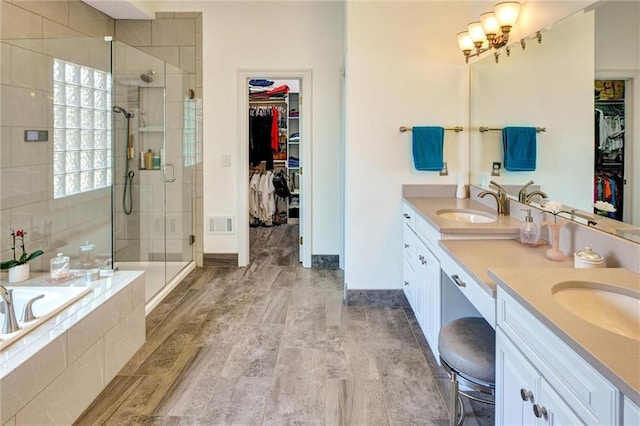 14780 S Glen Eyrie St, Olathe, KS 66061 - full bathroom with double vanity, a bath, a stall shower, and a spacious closet
