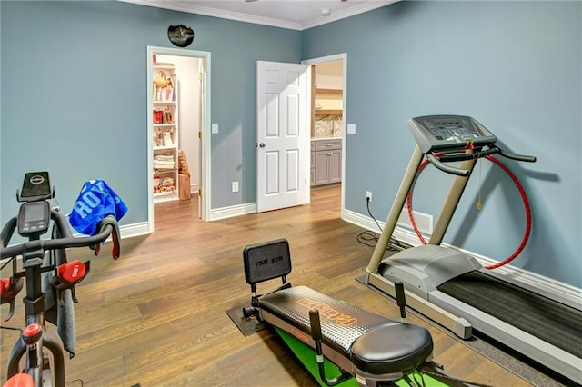 14780 S Glen Eyrie St, Olathe, KS 66061 - workout area featuring crown molding and wood finished floors