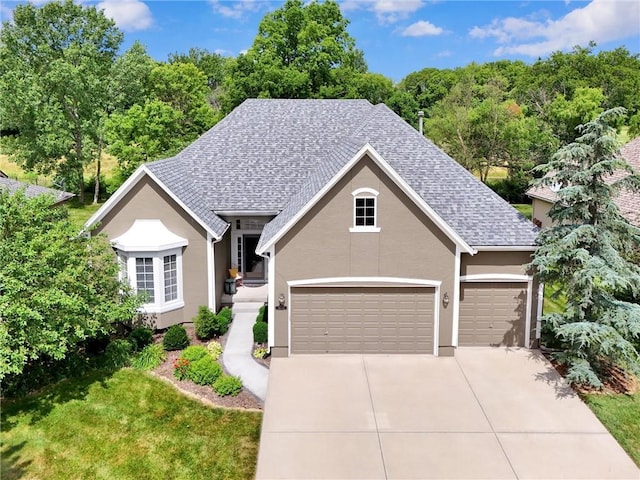 14780 S Glen Eyrie St, Olathe, KS 66061 - view of front of property with driveway, a shingled roof, stucco siding, and an attached garage