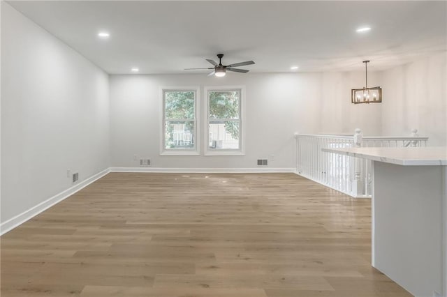 1101 SW Kingscross Rd, Blue Springs, MO 64014 - spare room featuring ceiling fan, recessed lighting, light wood finished floors, and a chandelier