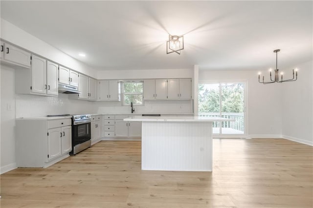 1101 SW Kingscross Rd, Blue Springs, MO 64014 - kitchen with a chandelier, stainless steel electric range oven, light wood-style flooring, light countertops, and recessed lighting