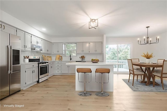 1101 SW Kingscross Rd, Blue Springs, MO 64014 - kitchen featuring stainless steel appliances, a chandelier, light wood-style flooring, light countertops, and recessed lighting