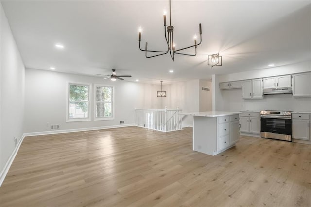 1101 SW Kingscross Rd, Blue Springs, MO 64014 - kitchen featuring stainless steel range with electric cooktop, light wood finished floors, a chandelier, a ceiling fan, and recessed lighting