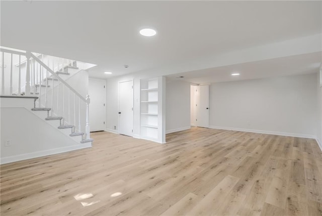 1101 SW Kingscross Rd, Blue Springs, MO 64014 - below grade area with light wood-type flooring, recessed lighting, stairs, and built in features