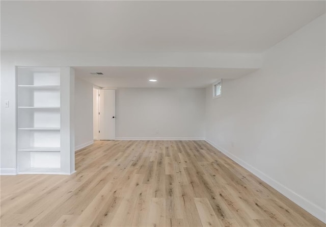 1101 SW Kingscross Rd, Blue Springs, MO 64014 - basement with built in shelves and light wood-style floors