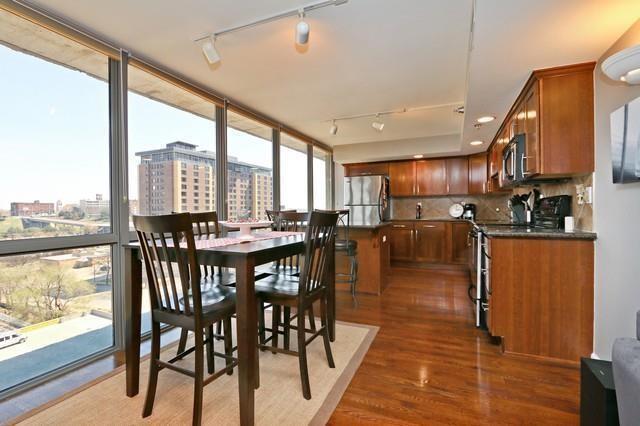 600 E Admiral Blvd Unit 1104, Kansas City, MO 64106 - dining space featuring rail lighting, dark wood-style flooring, and a view of city