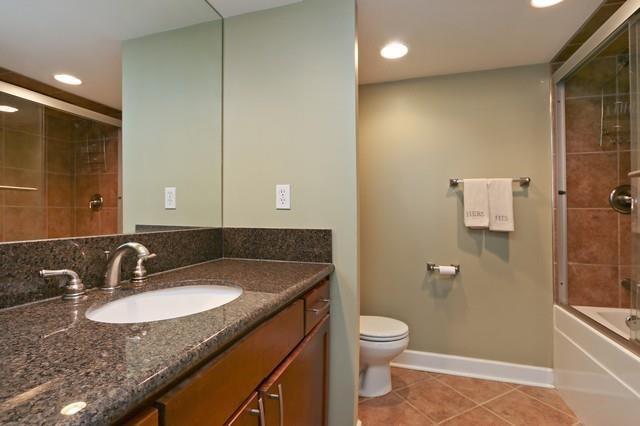 600 E Admiral Blvd Unit 1104, Kansas City, MO 64106 - full bath with tile patterned floors, vanity, recessed lighting, and combined bath / shower with glass door