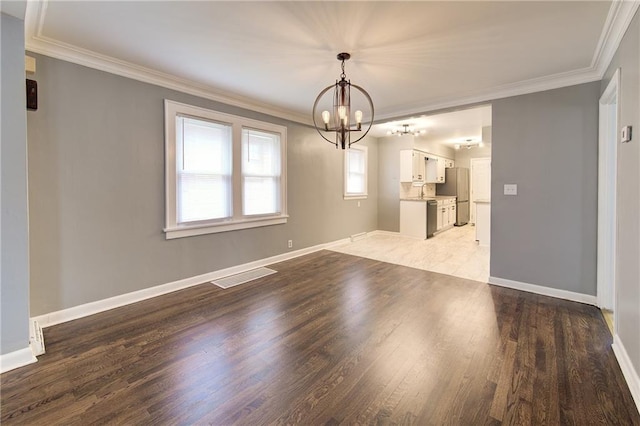 3624 Norledge Ave, Kansas City, MO 64123 - unfurnished room with a chandelier, ornamental molding, and light wood-style floors