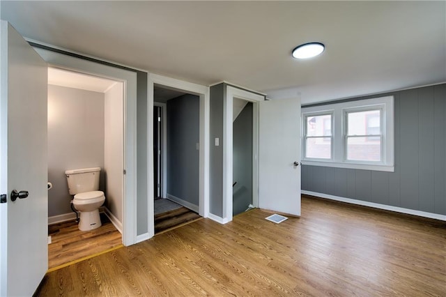 3624 Norledge Ave, Kansas City, MO 64123 - unfurnished bedroom with wood finished floors and baseboards