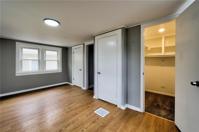 3624 Norledge Ave, Kansas City, MO 64123 - unfurnished bedroom featuring wood finished floors and a spacious closet