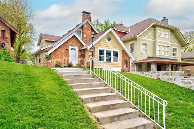 3624 Norledge Ave, Kansas City, MO 64123 - tudor home featuring a chimney and a front lawn